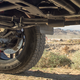 See that gear behind the brake? That’s the portal axle, it allows the axle to be mounted much higher than usual. (Image: Mark Victor Arnold)